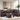 Heights brown reversible sectional with drop-down cup holders and matching storage ottoman covered in durable faux leather